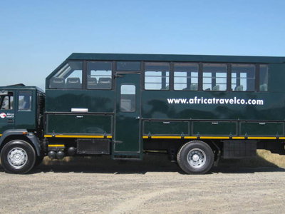 Groene overland truck voor de reis Truck en tent Zuidelijk Afrika op een onverharde weg.