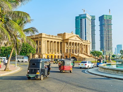 Tuktuks rijden langs het oude parlementsgebouw in Colombo, Sri Lanka.