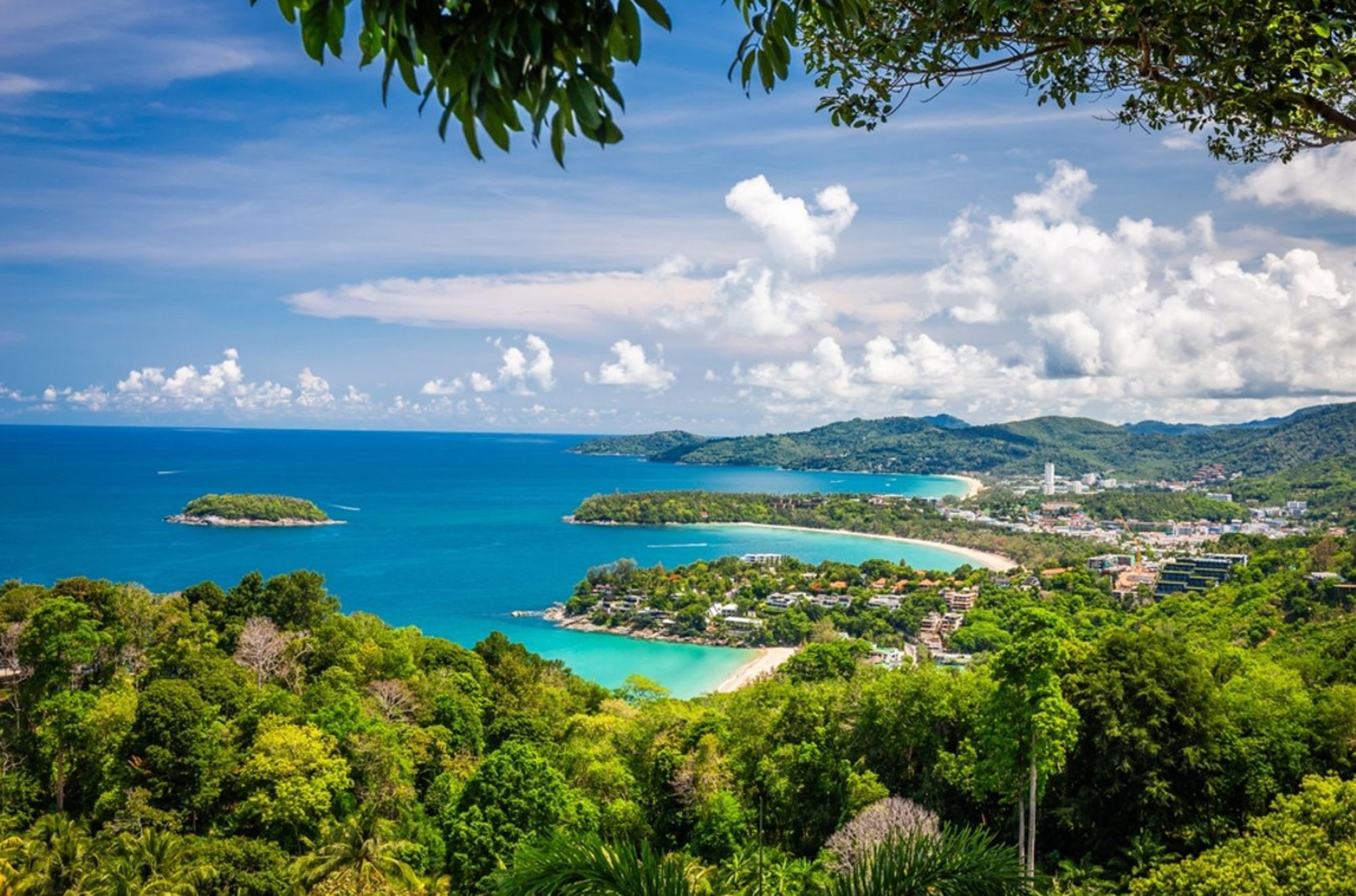 Panoramisch uitzicht op de kust van Phuket, Thailand, met groene heuvels, stranden en azuurblauwe zee.