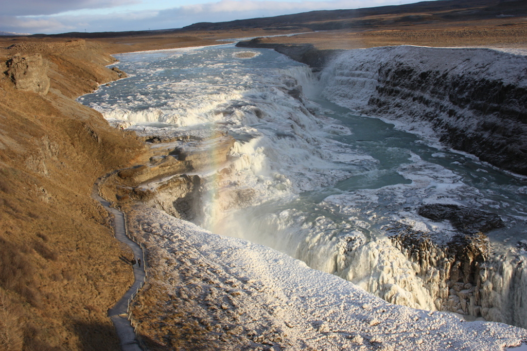Gullfoss-waterval in IJsland, met bevroren rotswanden en kolkend water in een diepe kloof.