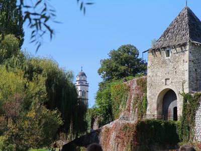 Stadsmuur met stenen poort en toren bij het fort van Banja Luka, met kerkkoepel op de achtergrond.