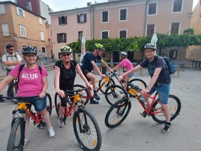 Fietstocht met de groep door een sfeervol dorp tijdens Route Slovenië, dag 7.