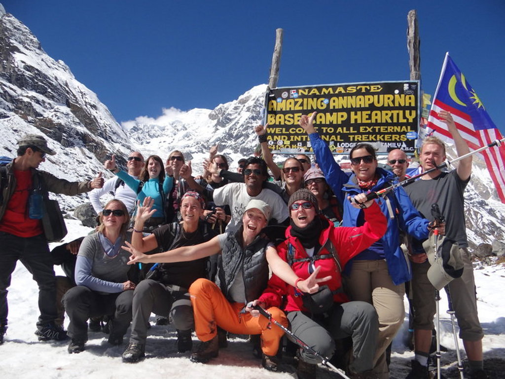 Groepsrondreis Nepal Annapurna Basecamp: trekkers poseren bij het bord van Annapurna Base Camp in de Himalaya.