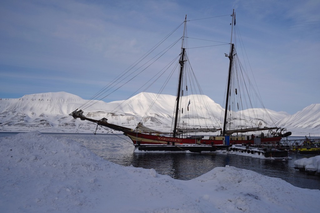 Zeilschip Noorderlicht voor besneeuwde bergen tijdens groepsrondreis om Spitsbergen.