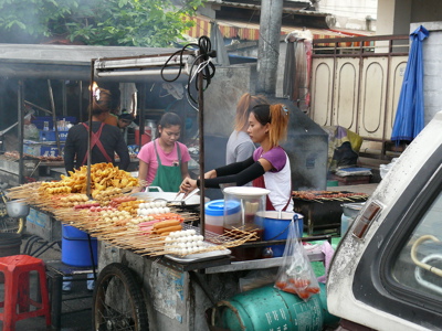 Straatkraam met satéspiesjes en snacks op een markt in Thailand, route Ko Samui.