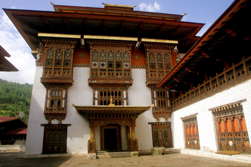 Traditionele Bhutanese dzong met rijk versierde houten ramen en witte muren, tijdens groepsrondreis Sikkim en Bhutan.