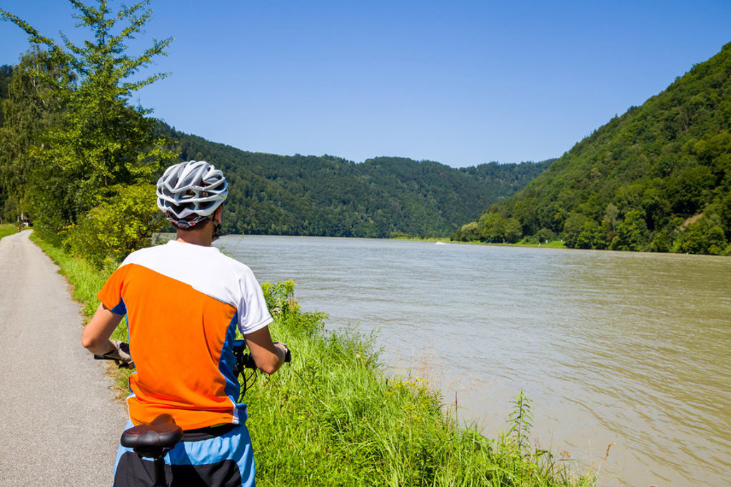 Fietser op een fietspad langs de Donau tijdens de fietsvakantie van Praag naar Wenen.