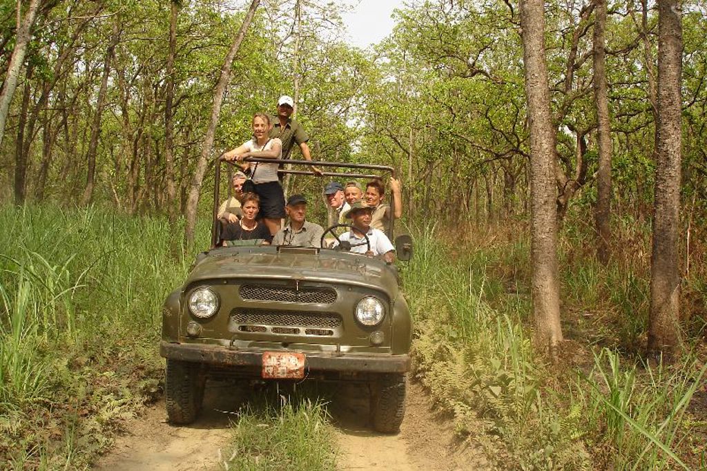 Groepsrondreis Nepal: jeepsafari met reizigers door een bosrijk natuurgebied.