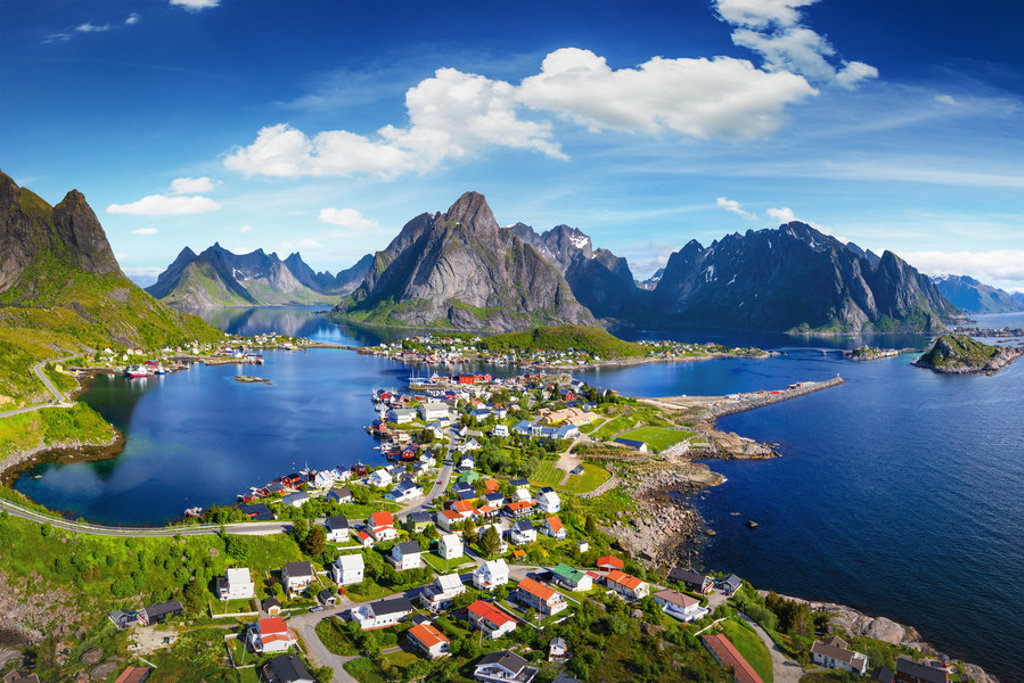 Uitzicht op een dorp aan de fjord met bergen op de Lofoten in Noorwegen tijdens een groepsrondreis.