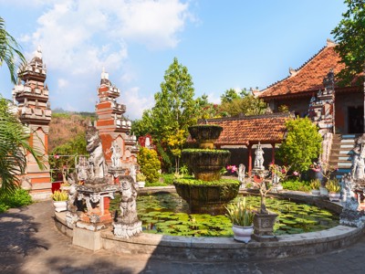 Balinese tempelcomplex met vijver vol waterlelies, fontein en beelden tijdens Route Bali 18 dagen.