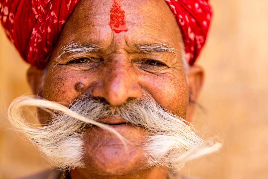 Portret van man met rode tulband, tilak en lange snor tijdens groepsrondreis Noord-India Compleet.