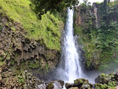 Hoge waterval in groene kloof met rotswanden op Sulawesi, tijdens de route Bali & Sulawesi.