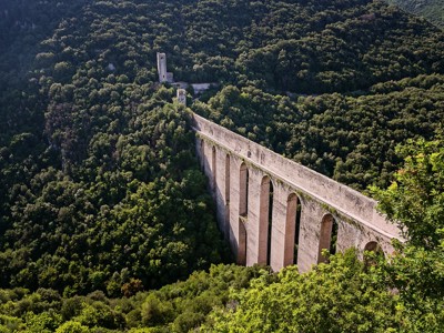 Hoog viaduct met bogen door een groene vallei in de Centrale Apennijnen, Italië.
