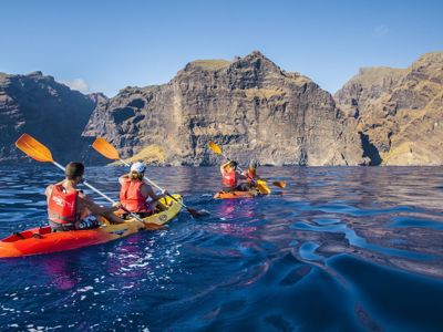 Kajakkers langs de hoge kliffen van Los Gigantes op Tenerife, Canarische Eilanden.