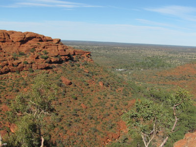 Uitzicht over Kings Canyon met rode rotswanden en groene vallei in de Australische outback.