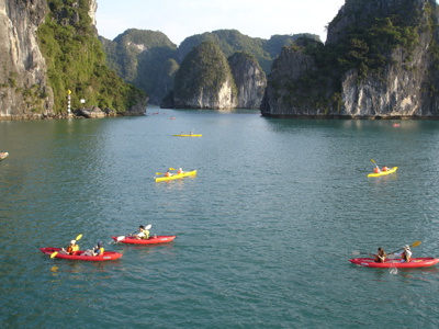 Kajakken tussen kalkstenen rotsen in Halong Bay, Vietnam, tijdens de Route Vietnam reis.