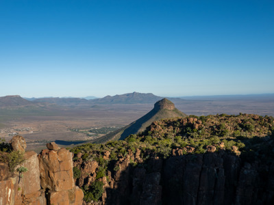 Uitzicht over de Karoo met rotsformaties en bergen langs de route Kaapstad–Johannesburg.