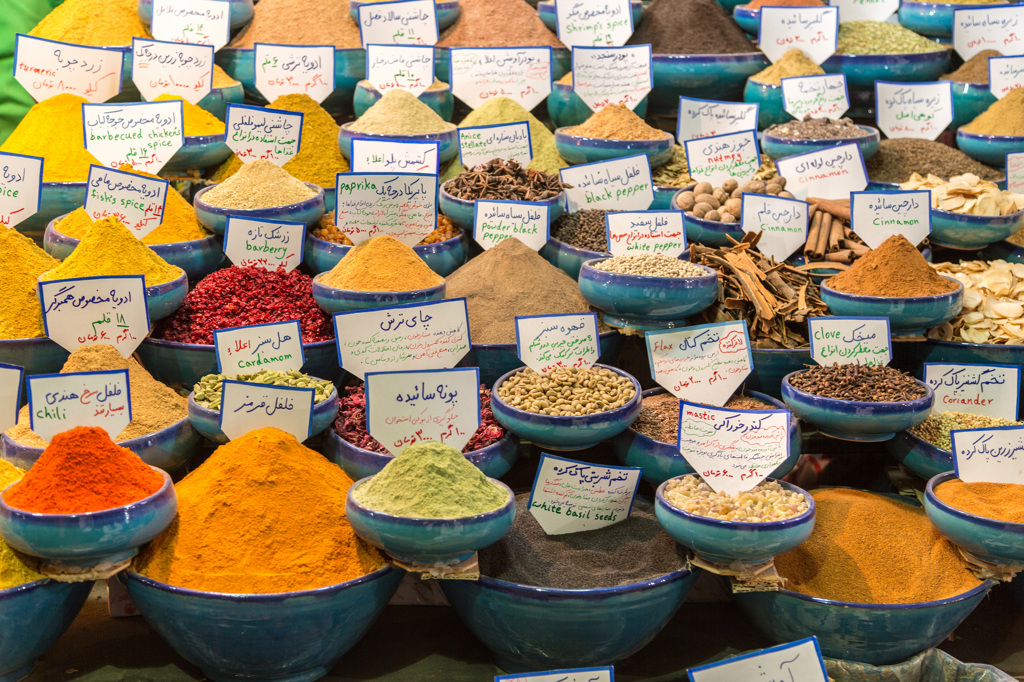 Kleurrijke specerijen in schalen op een bazaar in Iran tijdens een groepsrondreis.