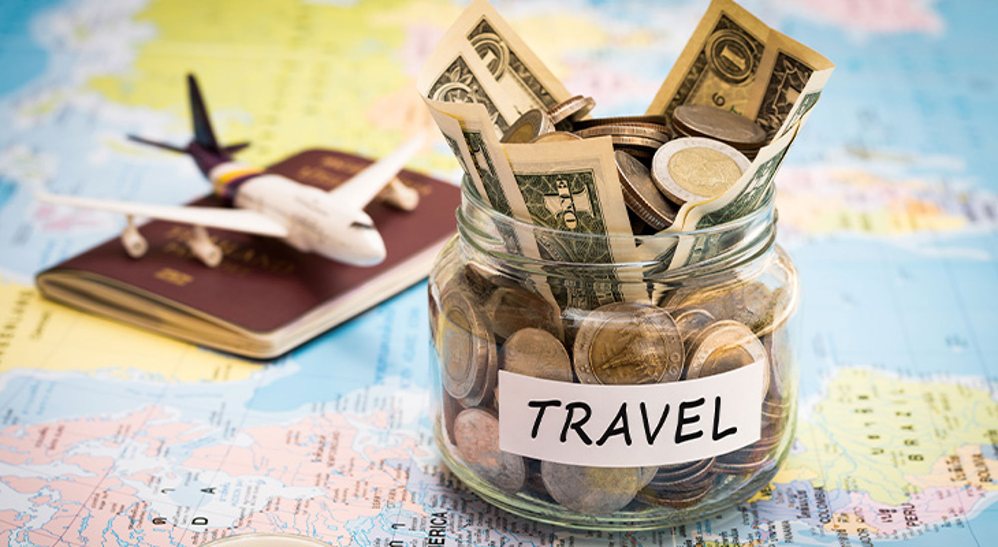 Cadeau voor reiziger geld Spaarpot met reisgeld, wereldkaart, paspoort en vliegtuigmodel voor het plannen van een vakantie.
