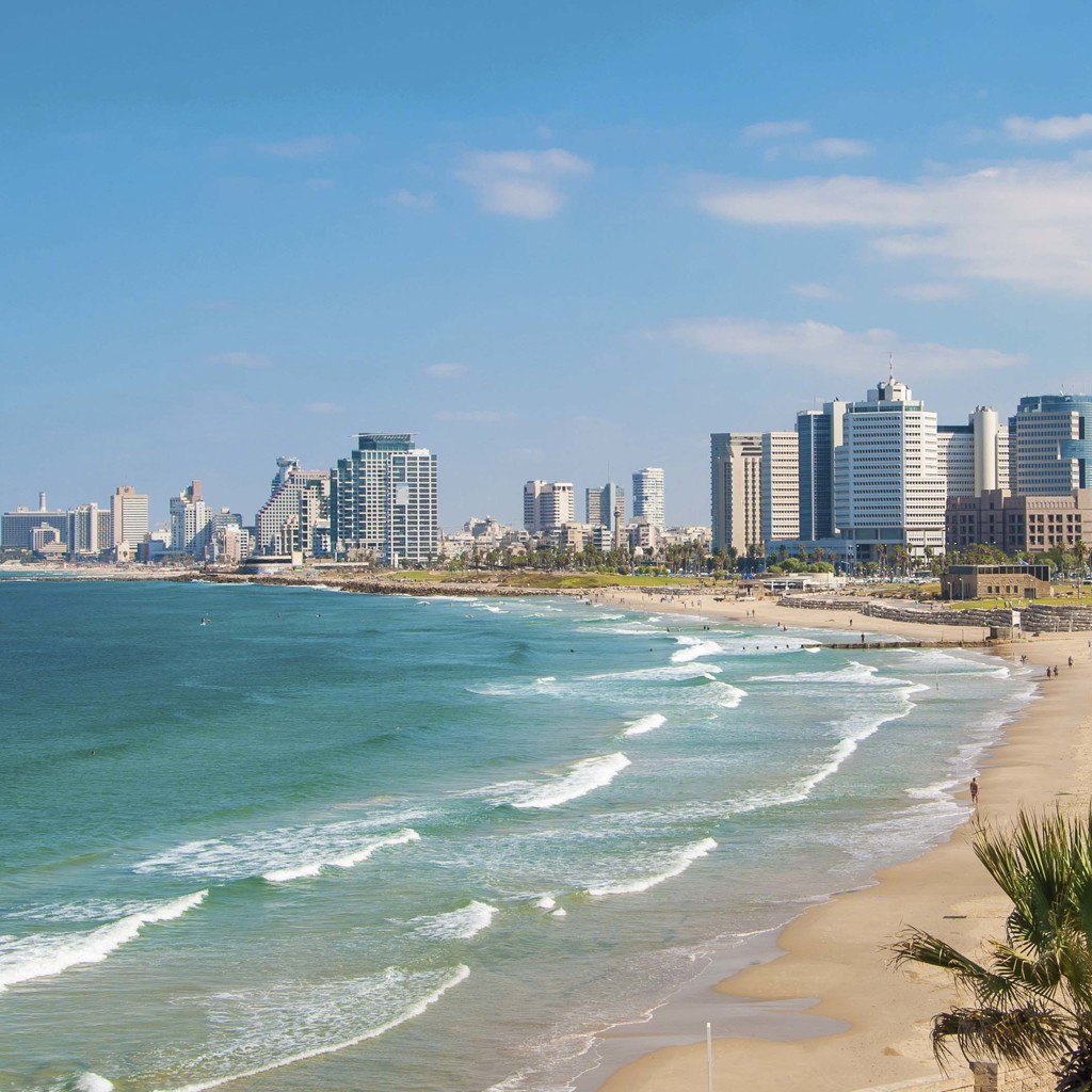 Skyline van Tel Aviv met zandstrand en golven langs de Middellandse Zee.