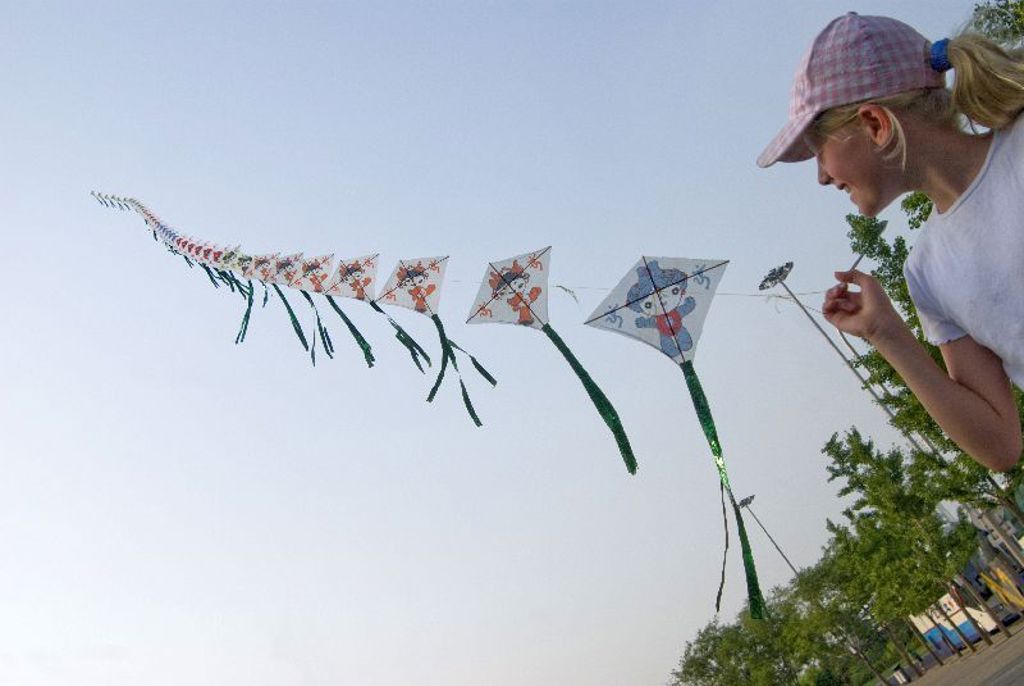 Meisje laat vliegers op in de lucht tijdens een familiereis China.