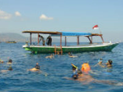 Snorkelaars in zee bij een boot tijdens de Route Bali en Lombok, 16 dagen.