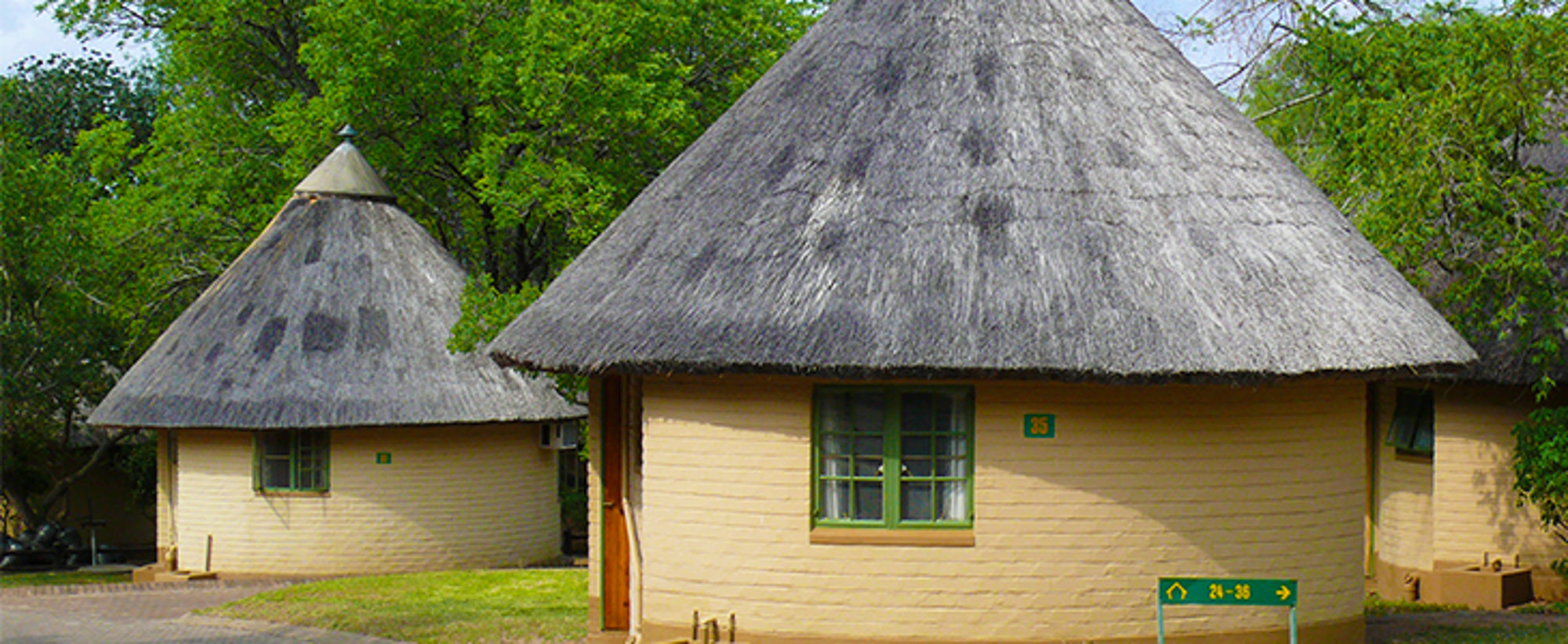 Rondavels in Zuid-Afrika Ronde bungalows met rieten daken in een groene omgeving.