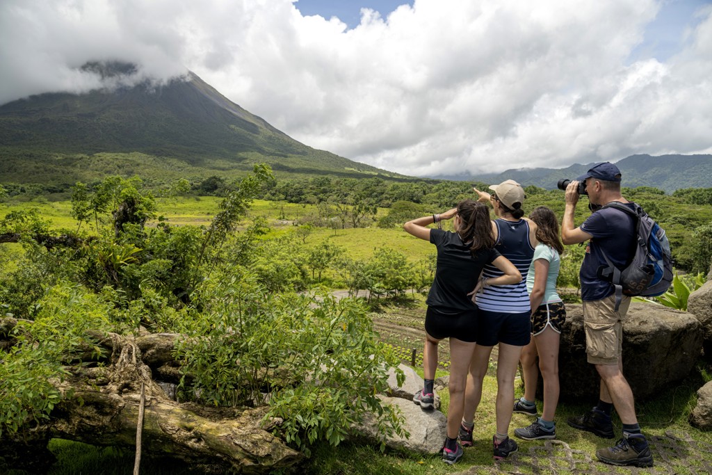 Gezin bewondert een vulkaanlandschap tijdens een familiereis in Costa Rica.