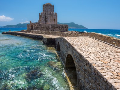 Venetiaans fort bij Methoni aan de Peloponnesos, met stenen brug over helderblauw zeewater in Griekenland.