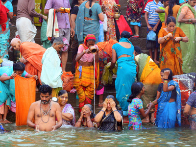 Pelgrims baden en voeren rituelen uit bij de ghats van de Ganges in Varanasi, India.