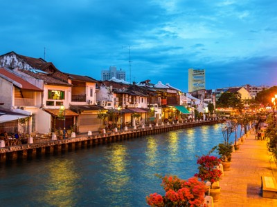 Avondzicht op de Malacca River met sfeervolle kade en historische panden in Melaka, Maleisië.