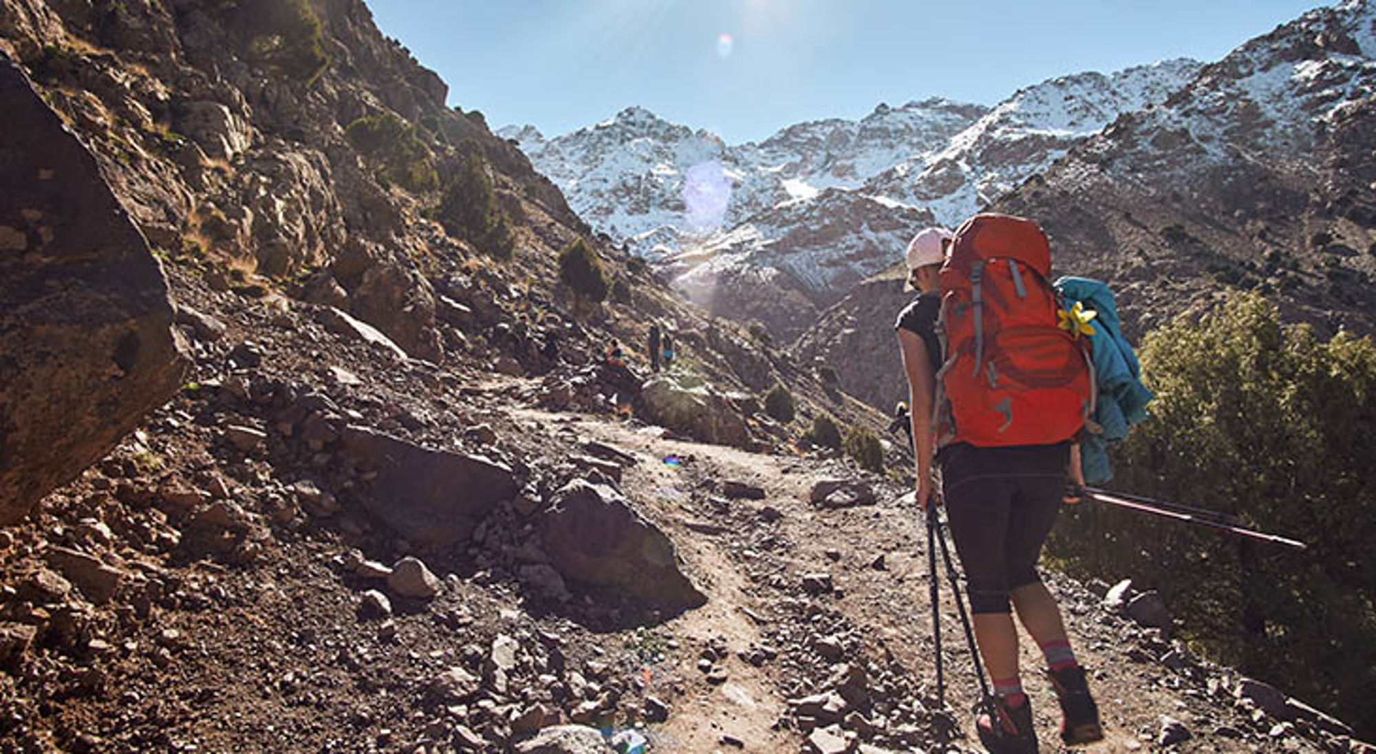 Toubkal Wandelaar op bergpad in het Atlasgebergte, Marokko, met besneeuwde toppen op de achtergrond.