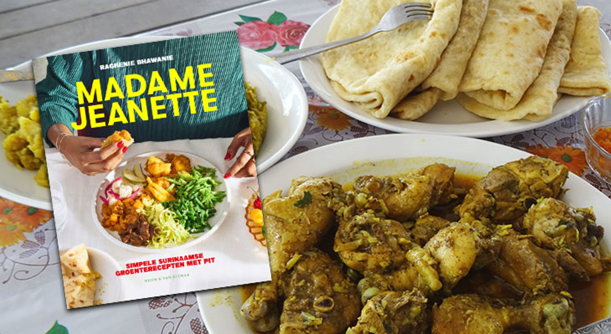 Kookboek Madame Jeanette naast Surinaamse maaltijd met roti en kip op tafel.