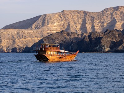 Traditionele dhow-cruise langs de ruige kust en bergen van Oman tijdens de Route Oman en Dubai.
