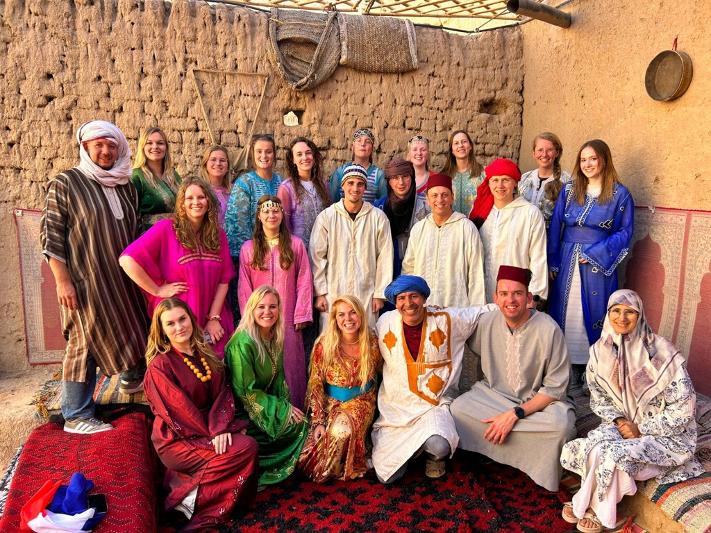 Groep 22-35ers in traditionele kleding tijdens een groepsrondreis door Marokko.