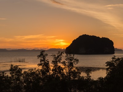 Zonsondergang boven de Andamanse Zee met silhouet van een eiland, Route Zuid-Thailand.