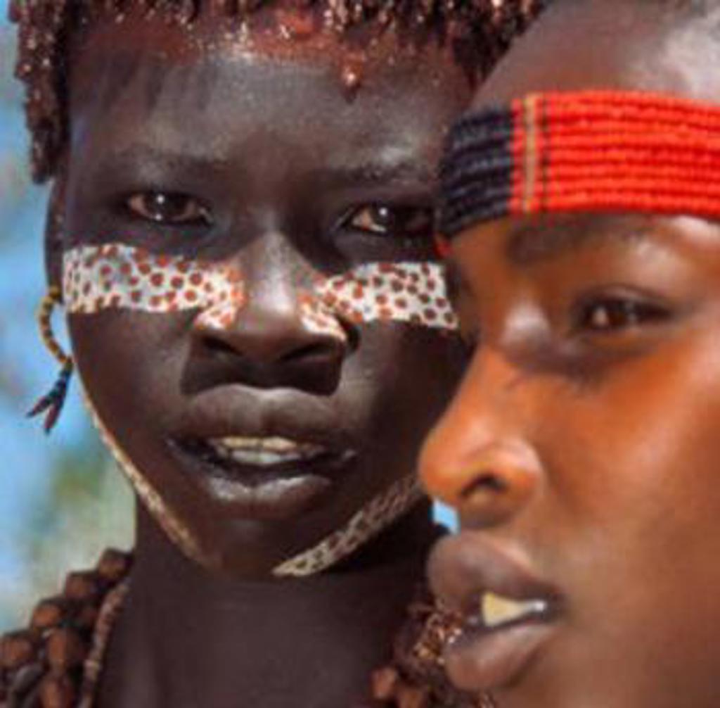 Portret van twee mensen met traditionele gezichtsverf en hoofdband tijdens een groepsrondreis in Ethiopië.
