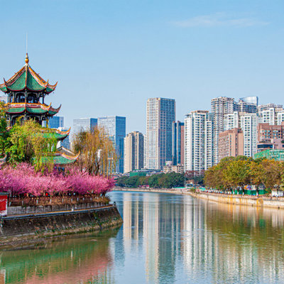 Traditionele pagode aan de rivier met moderne skyline, tijdens een familiereis door China.