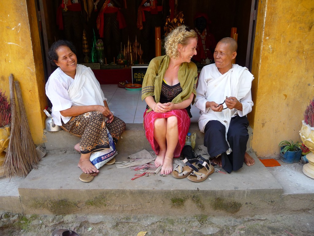 Reiziger in gesprek met twee locals bij een tempel in Cambodja tijdens groepsrondreis Cambodja en Thailand.
