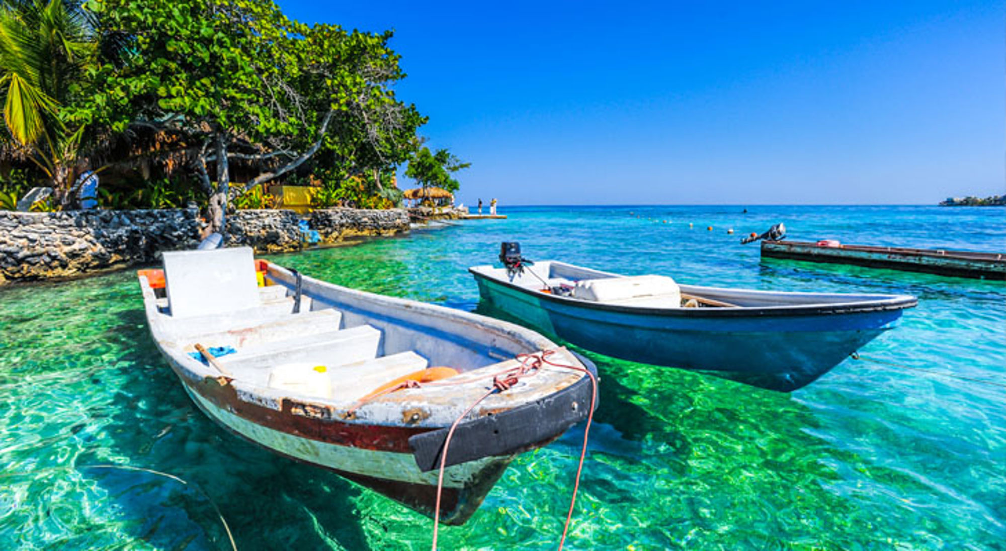 Rosario eilanden Bootjes in helder turquoise water bij een tropisch strand in Colombia.