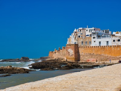 Stadswallen en witte huizen aan zee in Essaouira, Marokko.