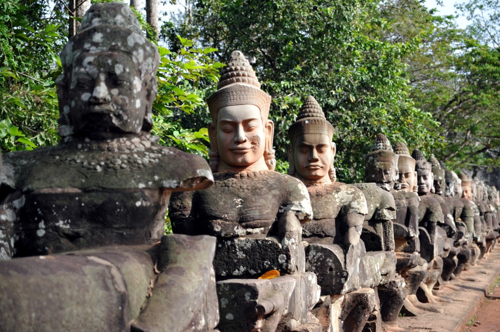 Rij stenen wachters langs de brug bij Angkor Thom, Cambodja.