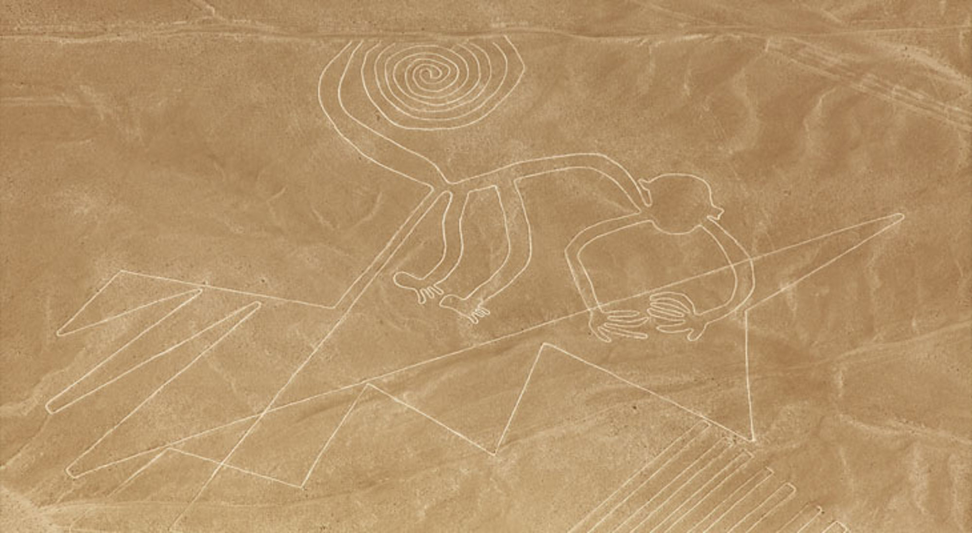 Nazcalijnen Nazca-lijnen in Peru met de geoglief van een aap op de woestijnbodem.